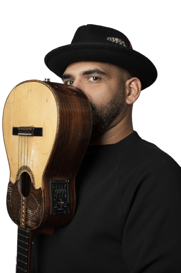 Jorge Glem hiding half of his face behind a Venezuelan cuatro