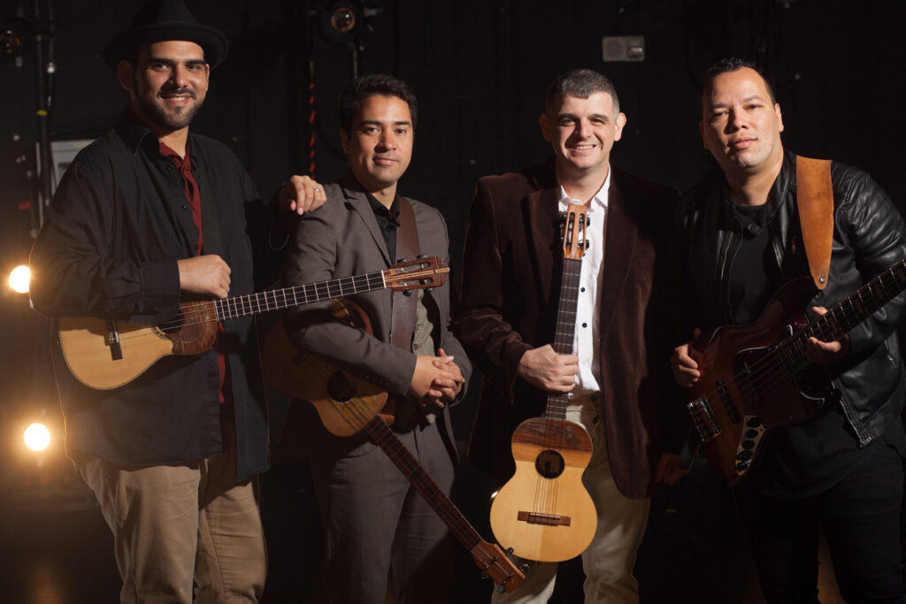 The four members of C4 Trío holding their instruments